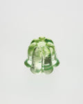 Green glass object on a light gray background