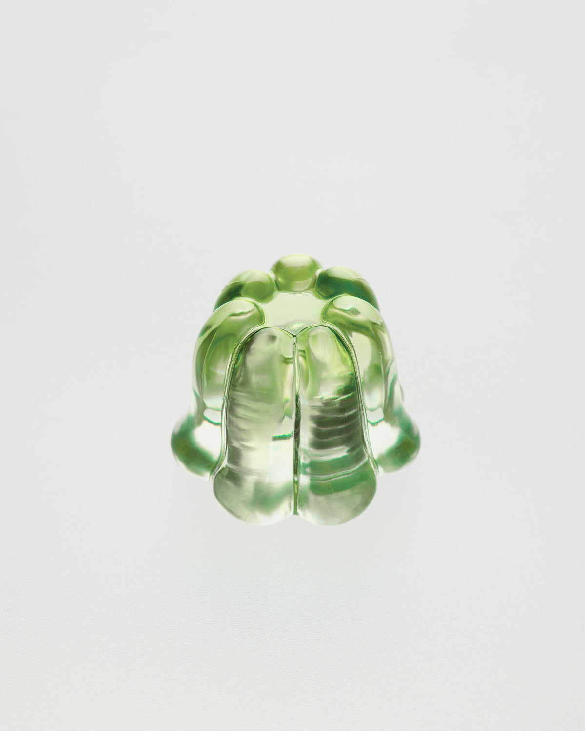 Green glass object on a light gray background